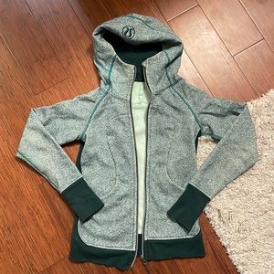 Green hooded Lululemon athletic jacket